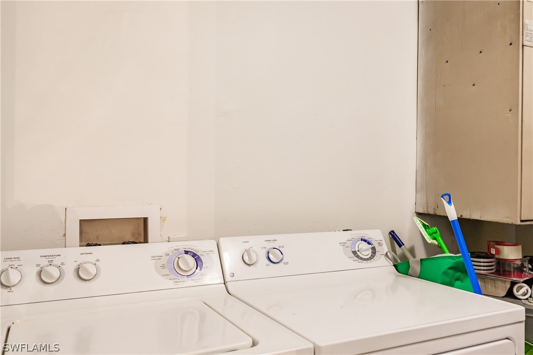 5737 Whitaker Road, Unit C201 Naples, FL 34112 - Photo 25 of 32 a utility room with dryer and washer