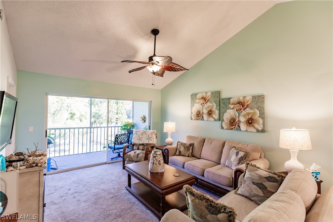 5737 Whitaker Road, Unit C201 Naples, FL 34112 - Photo 7 of 32 a living room with furniture and a large window