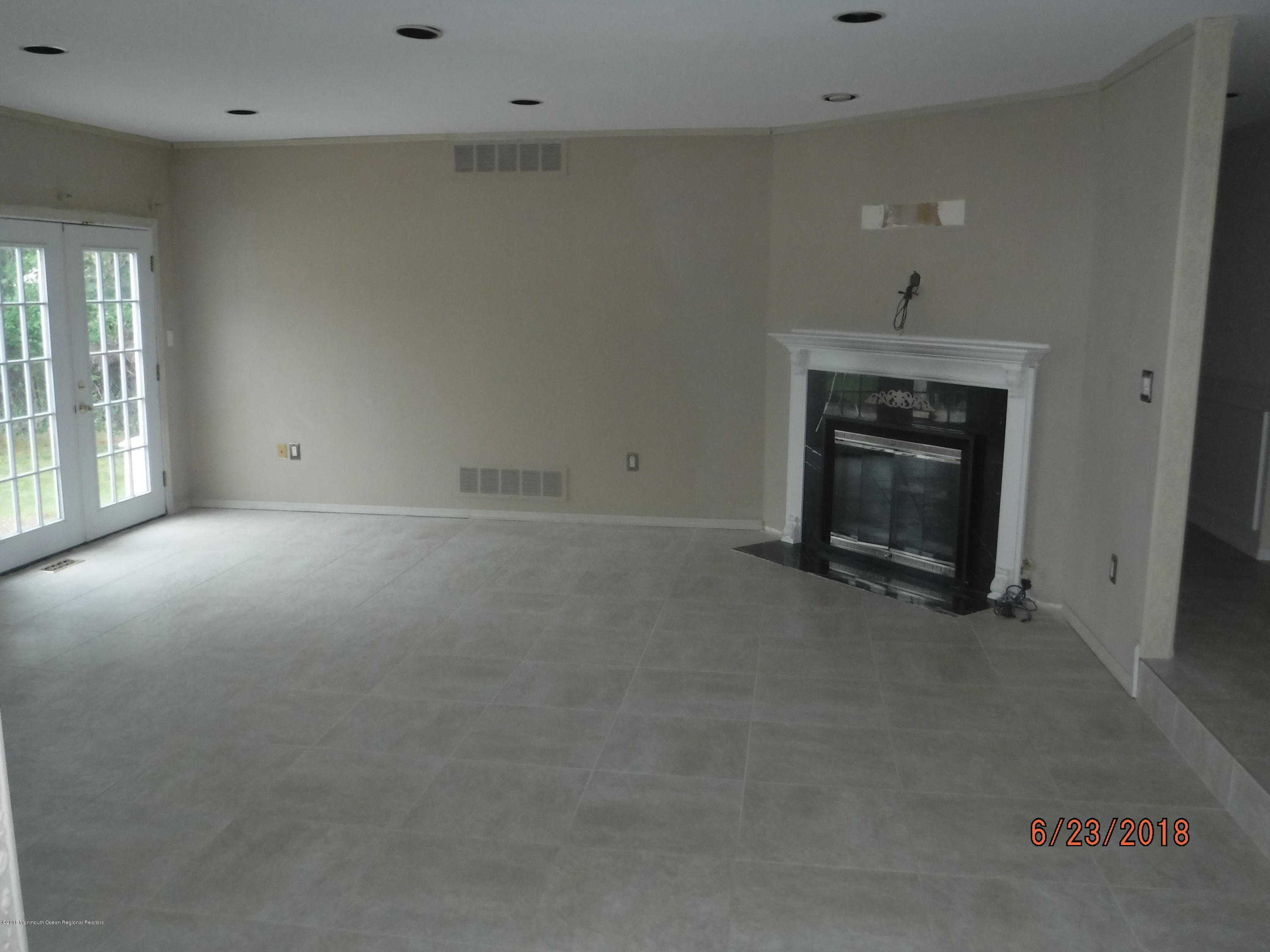 17 Crow Hill Road Freehold, NJ 07728 - Photo 18 of 44 an empty room with a fireplace