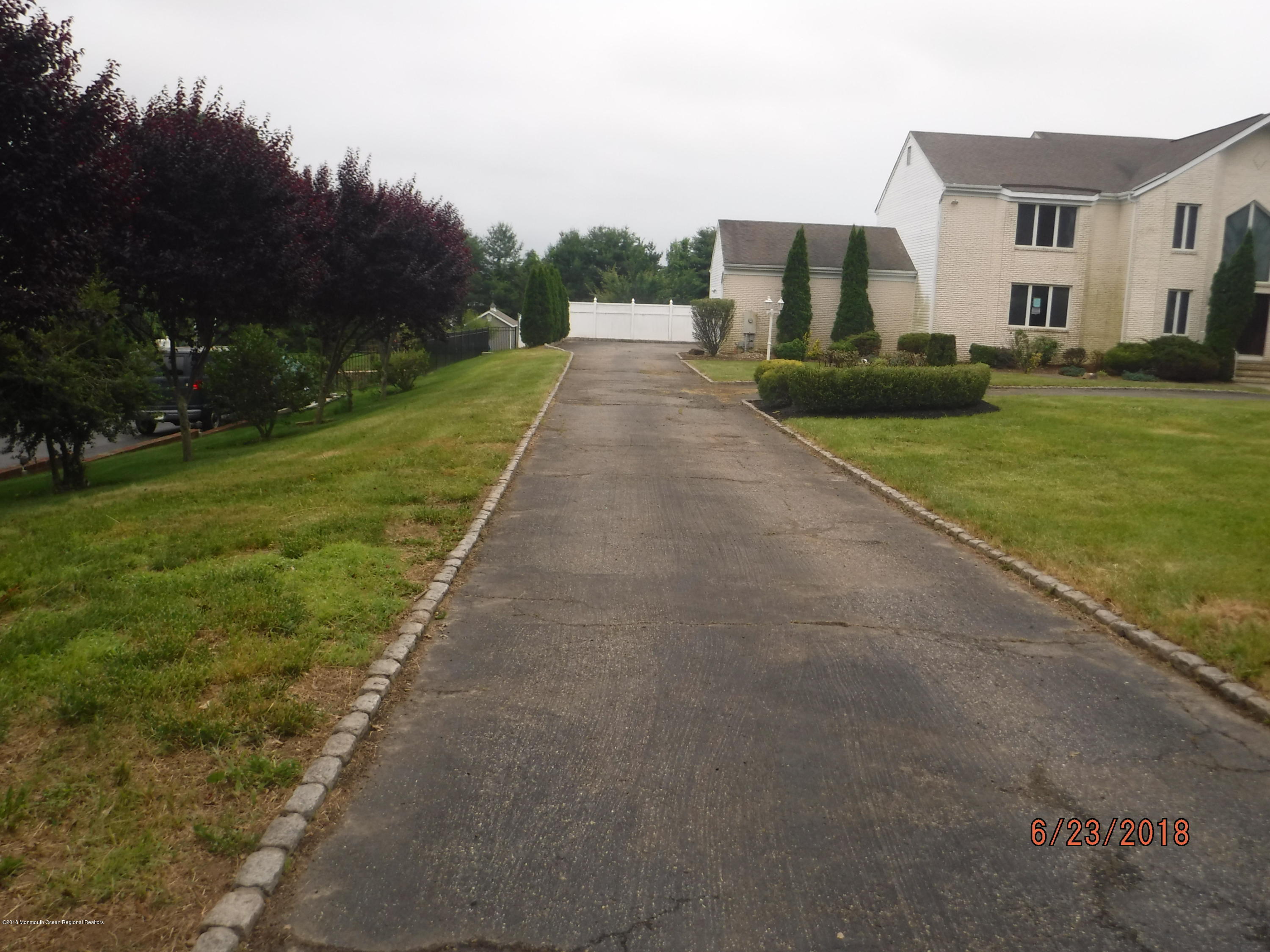 17 Crow Hill Road Freehold, NJ 07728 - Photo 3 of 44 a view of a white house with a big yard plants and large trees