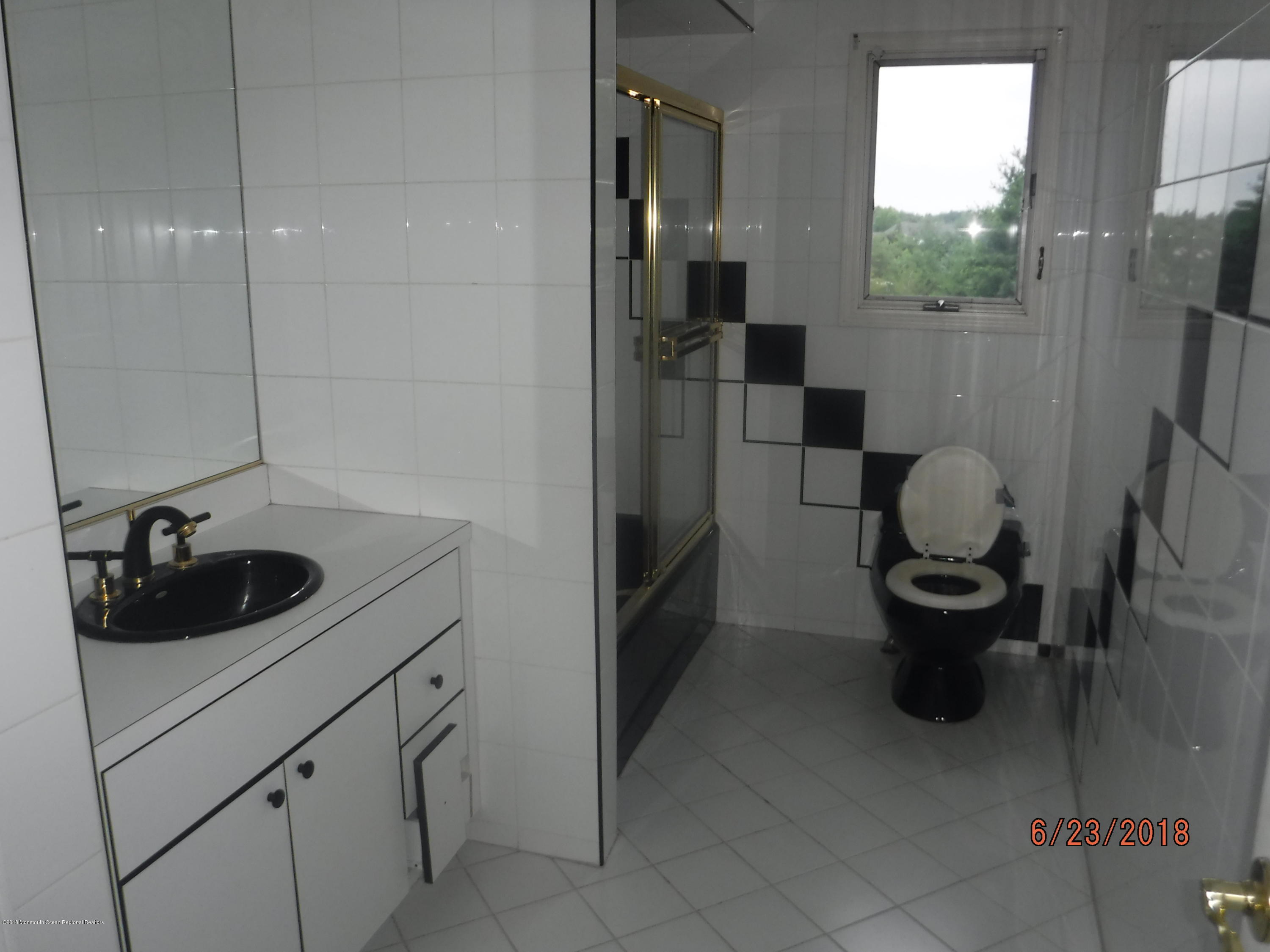 17 Crow Hill Road Freehold, NJ 07728 - Photo 37 of 44 a kitchen with a sink and a refrigerator
