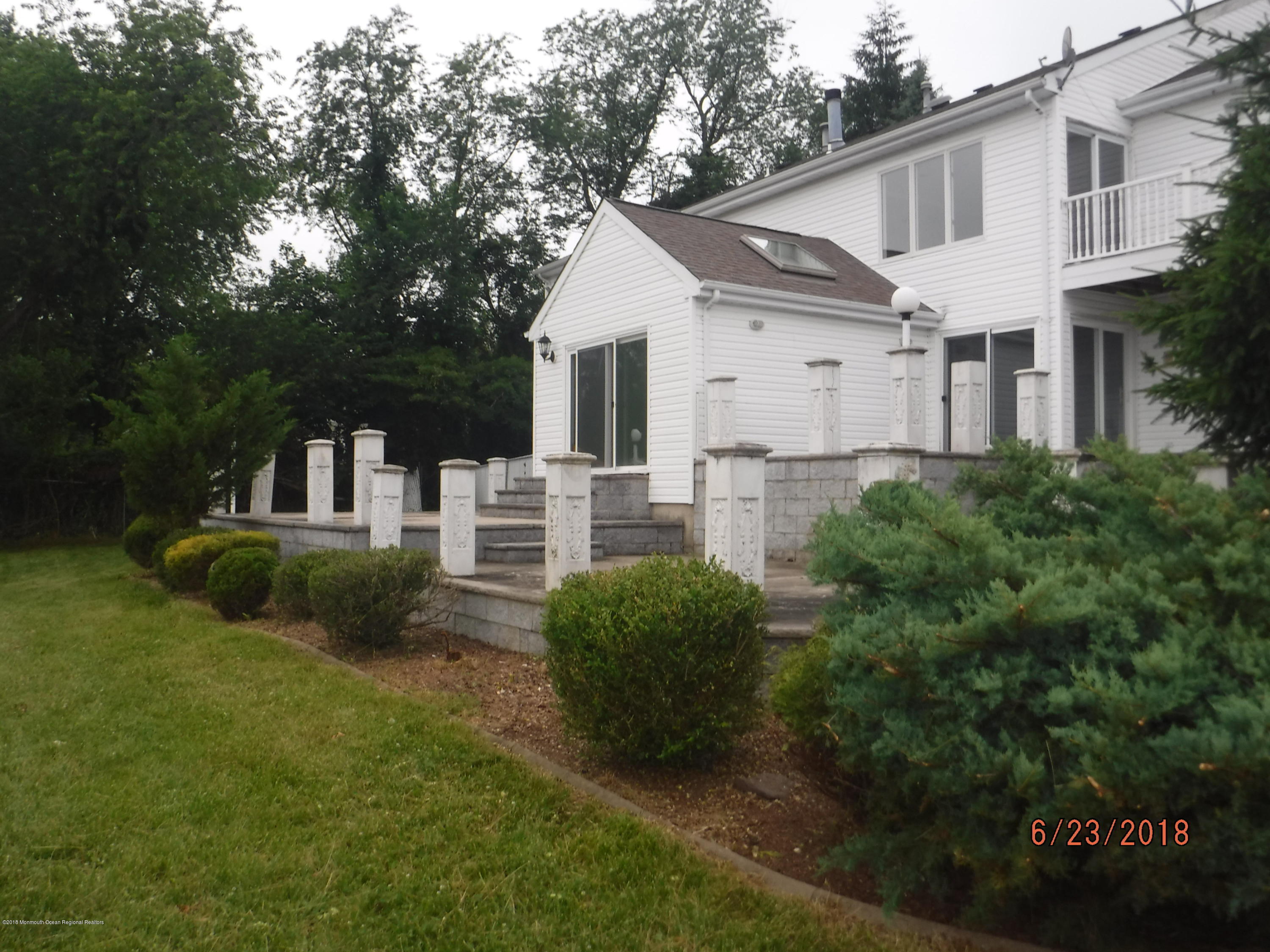 17 Crow Hill Road Freehold, NJ 07728 - Photo 5 of 44 a front view of a house with a yard and trees