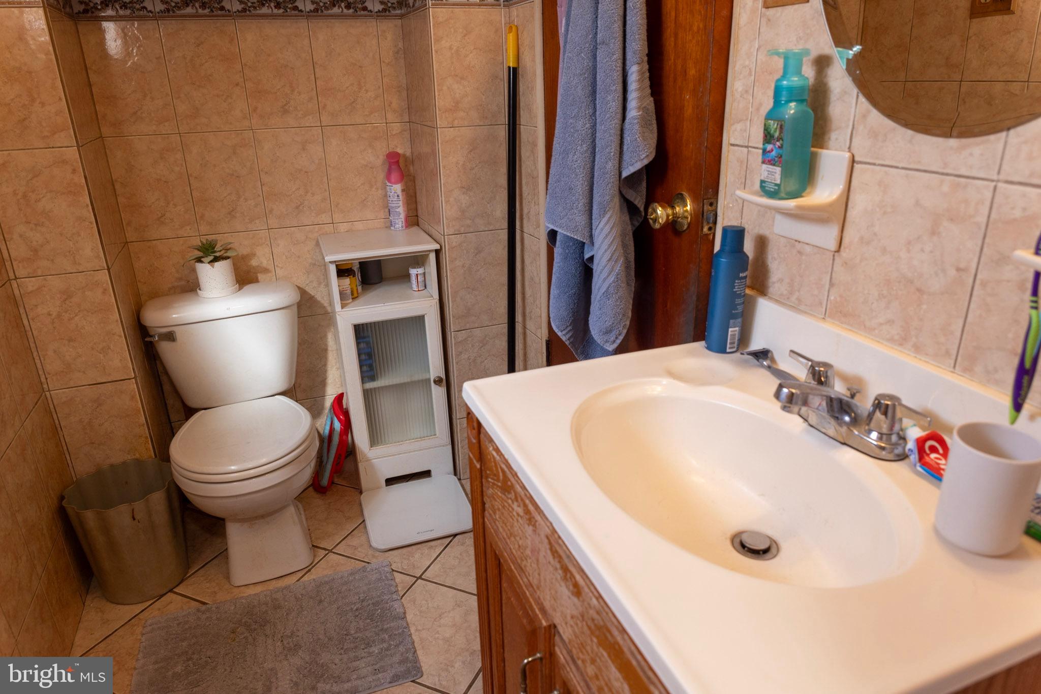 2986 Chatham Street Philadelphia, PA 19134 - Photo 11 of 14 a bathroom with a sink a toilet and a mirror