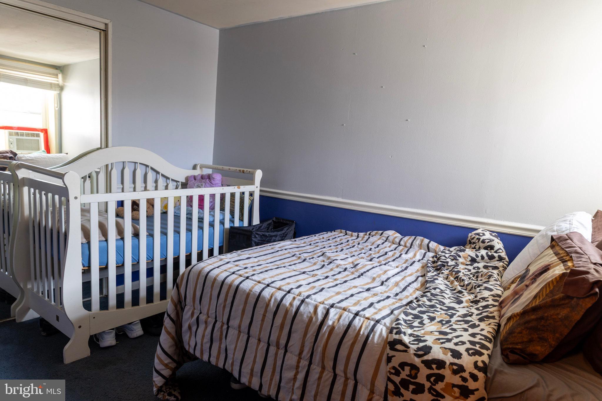 2986 Chatham Street Philadelphia, PA 19134 - Photo 12 of 14 a bed sitting in a bedroom next to a window