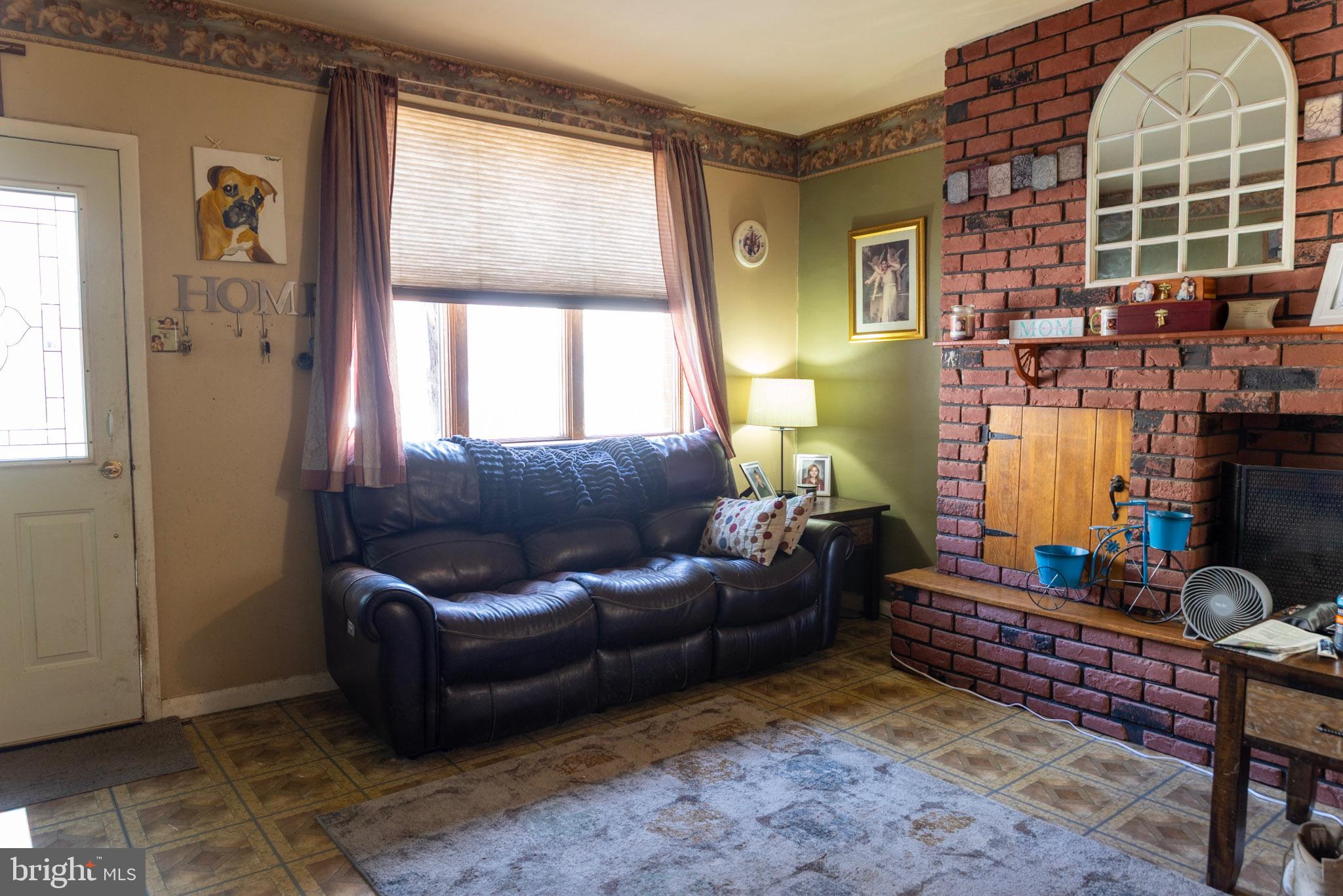 2986 Chatham Street Philadelphia, PA 19134 - Photo 4 of 14 a living room with furniture a window and a potted plant