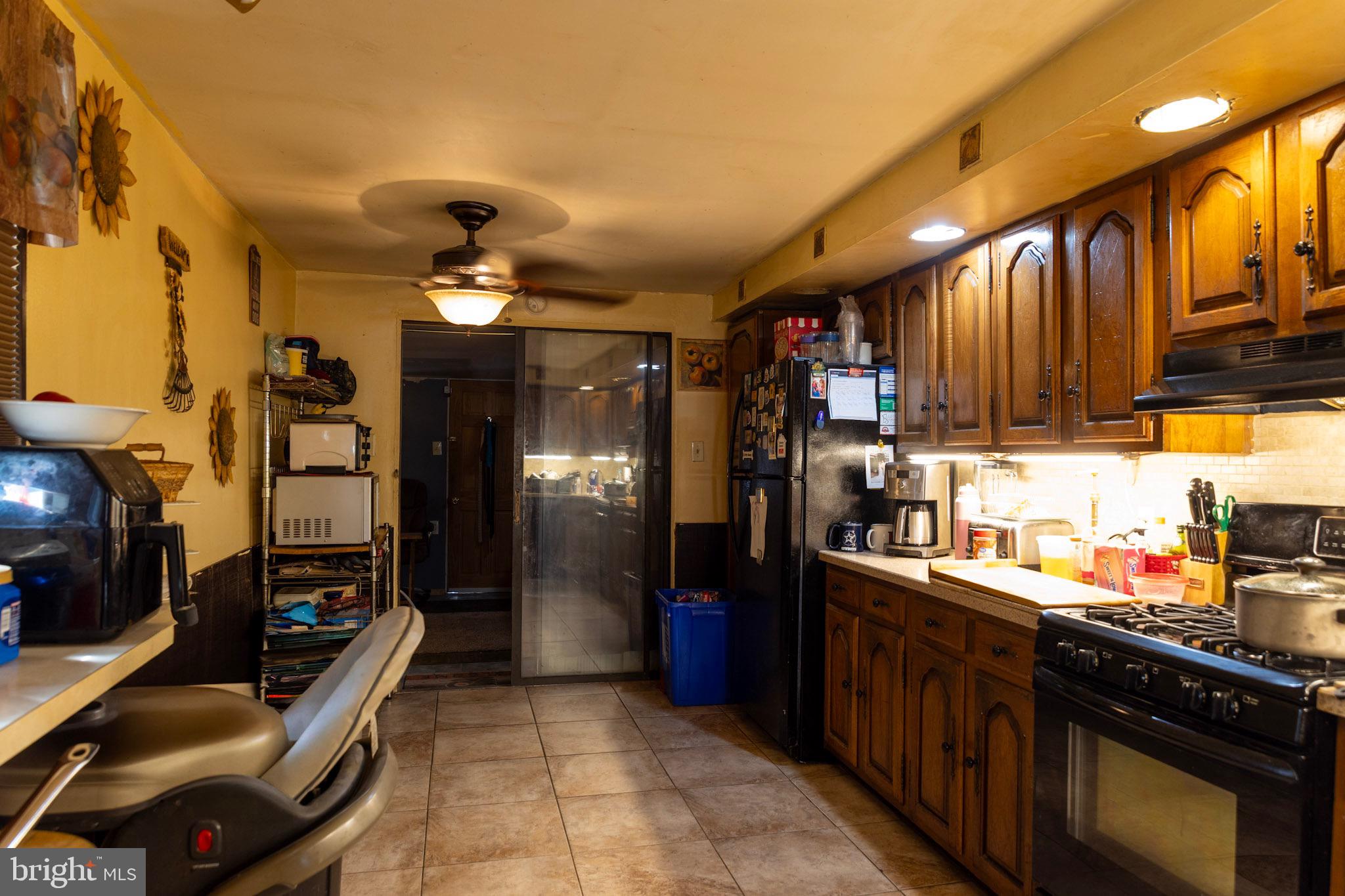 2986 Chatham Street Philadelphia, PA 19134 - Photo 5 of 14 a kitchen with stainless steel appliances kitchen island granite countertop a refrigerator a stove top oven a sink and dishwasher