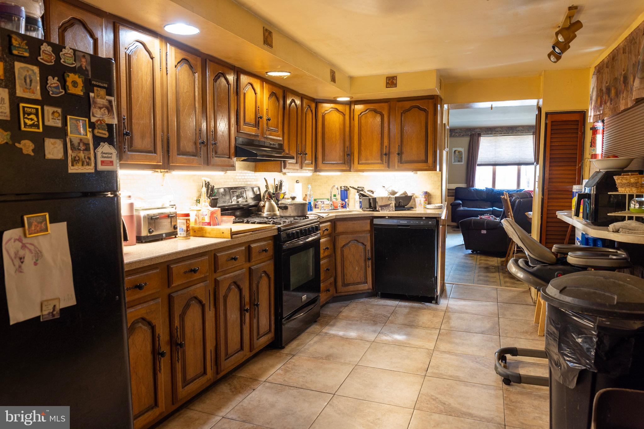 2986 Chatham Street Philadelphia, PA 19134 - Photo 7 of 14 a kitchen with a sink stove and cabinets