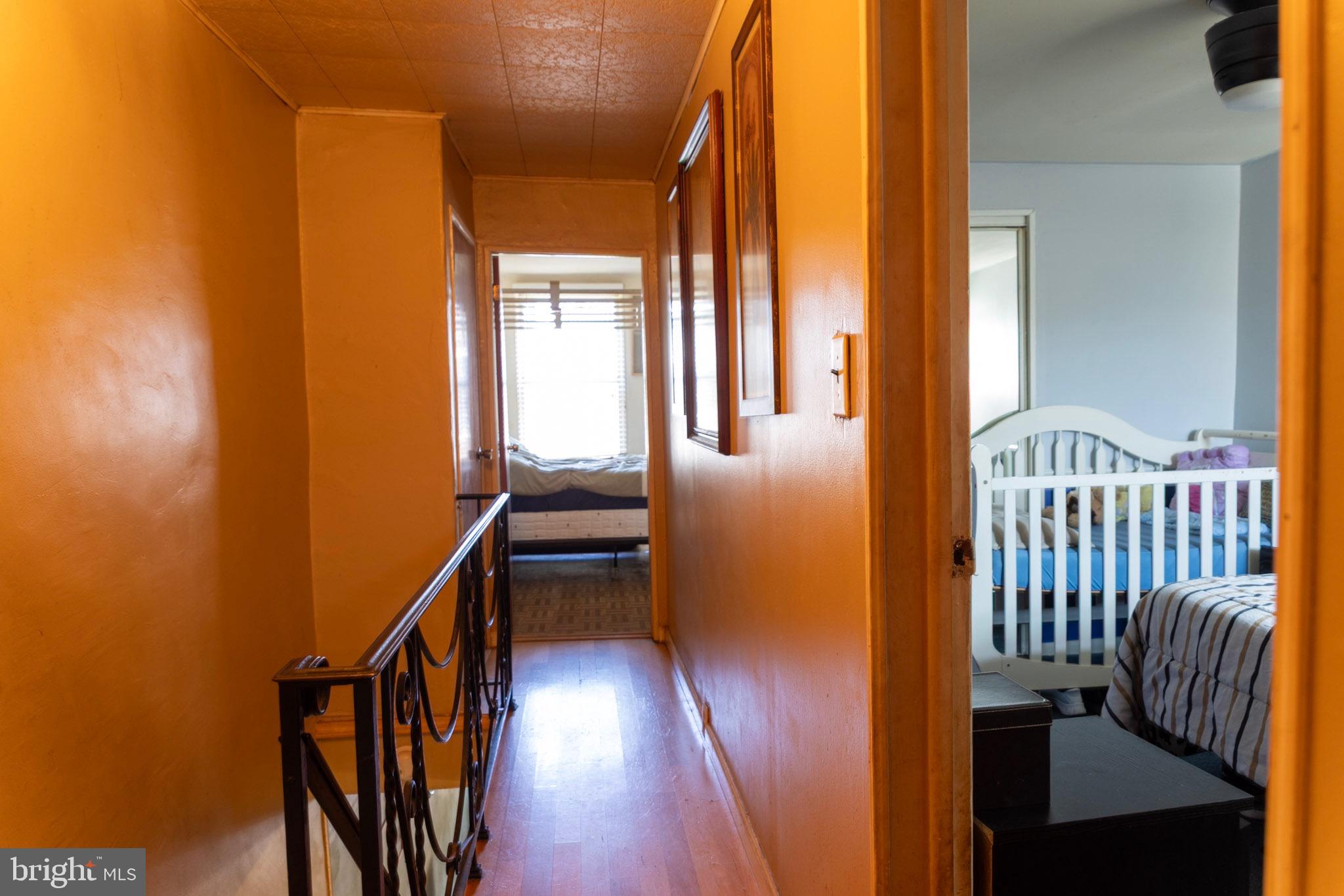 2986 Chatham Street Philadelphia, PA 19134 - Photo 9 of 14 a view of staircase with wooden floor and chair