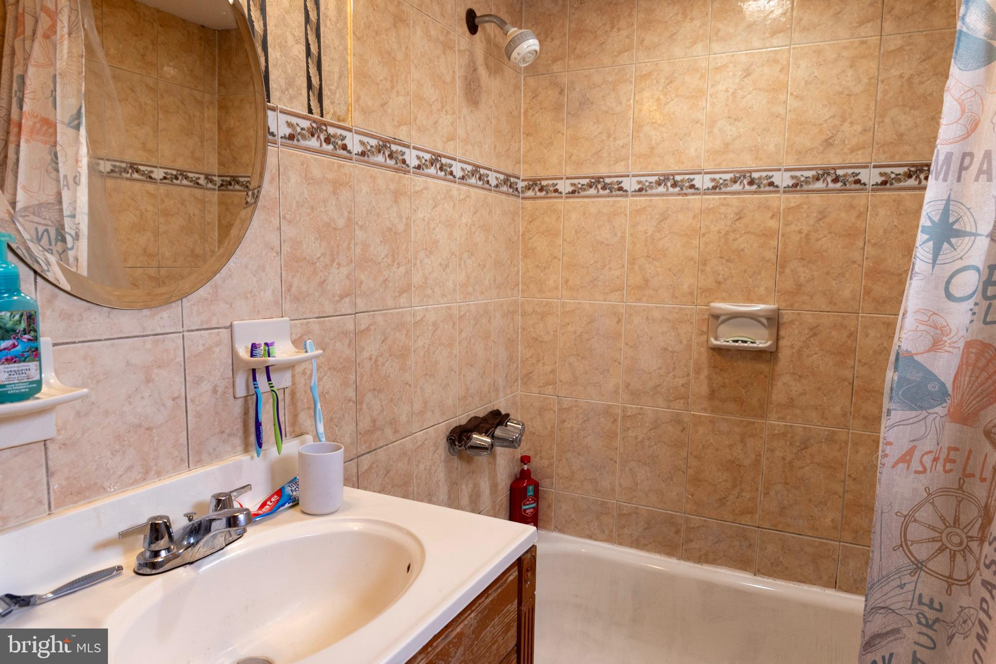 2986 Chatham Street Philadelphia, PA 19134 - Photo 10 of 14 a bathroom with a sink and a shower
