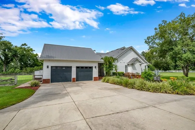 a view of empty room with wooden floor and windows