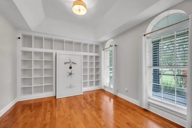 a kitchen with stainless steel appliances granite countertop a sink a stove and a wooden floors