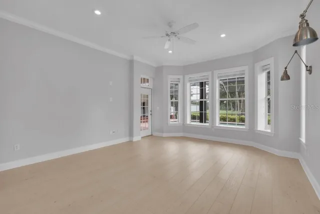 a view of grassy field with benches and trees all around