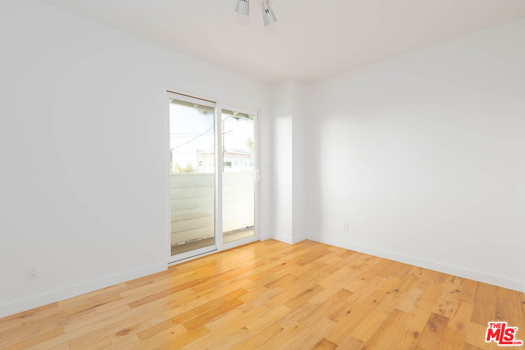 1016 Sanborn Avenue, Unit 101 Los Angeles, CA 90029 - Photo 14 of 18 a view of empty room with wooden floor and fan