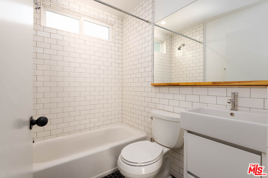 1016 Sanborn Avenue, Unit 101 Los Angeles, CA 90029 - Photo 16 of 18 a bathroom with a sink toilet and shower
