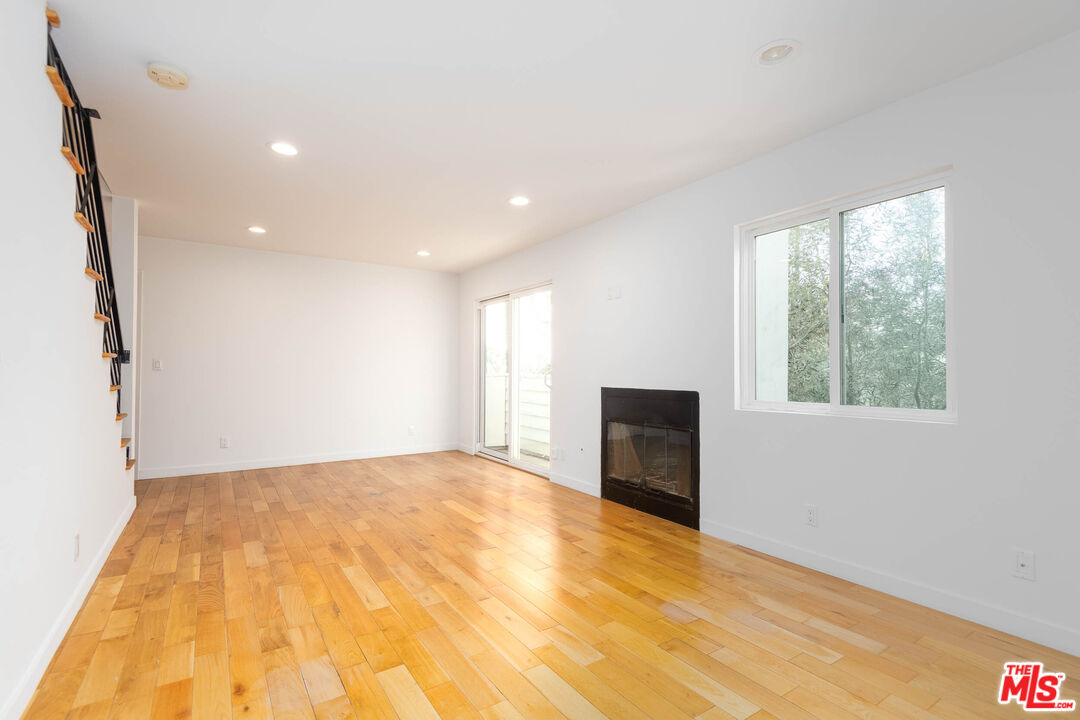 1016 Sanborn Avenue, Unit 101 Los Angeles, CA 90029 - Photo 2 of 18 a view of an empty room with a fireplace and a window
