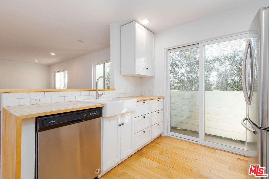 1016 Sanborn Avenue, Unit 101 Los Angeles, CA 90029 - Photo 6 of 18 a kitchen with granite countertop a sink and a stove