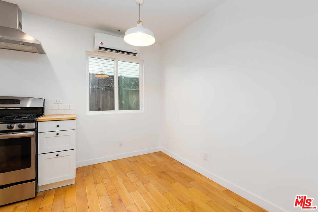 1016 Sanborn Avenue, Unit 101 Los Angeles, CA 90029 - Photo 8 of 18 a room with a bed and a window