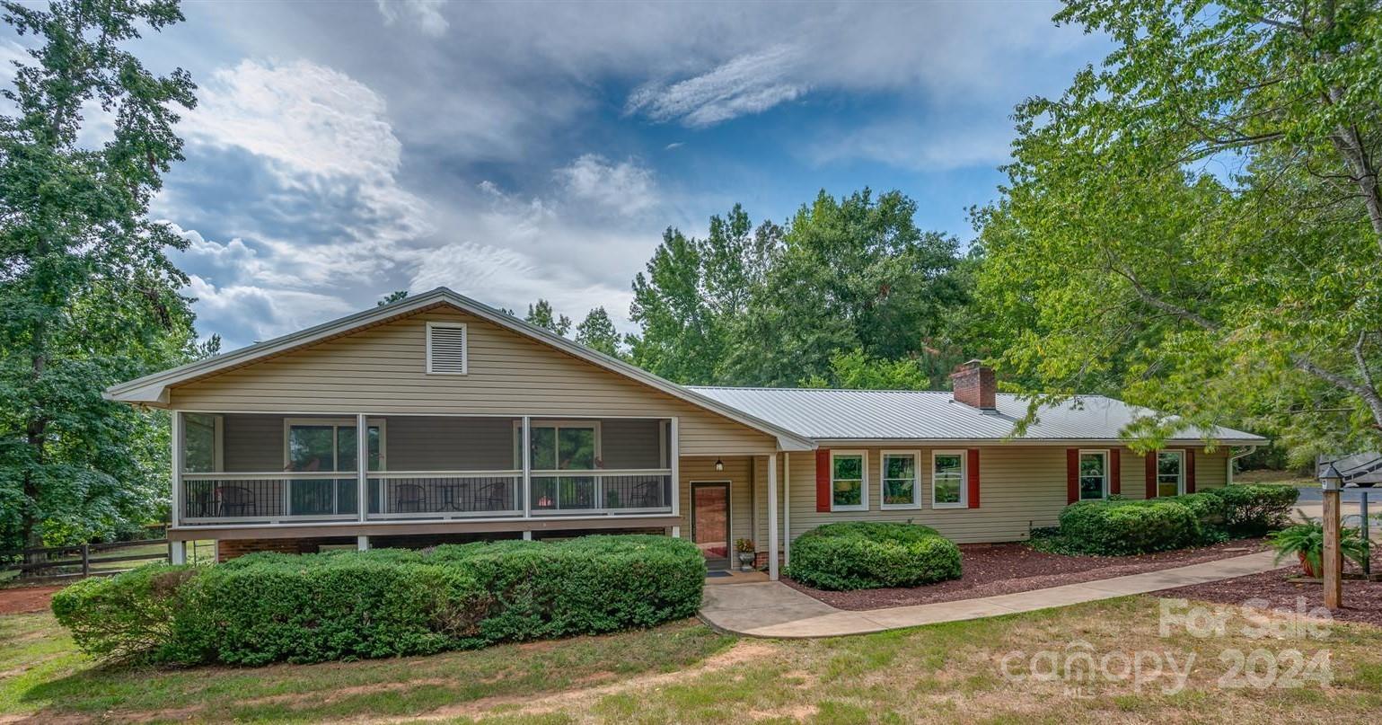 2316 Golf Course Road Columbus, NC 28722 - Photo 1 of 33 a front view of a house with garden