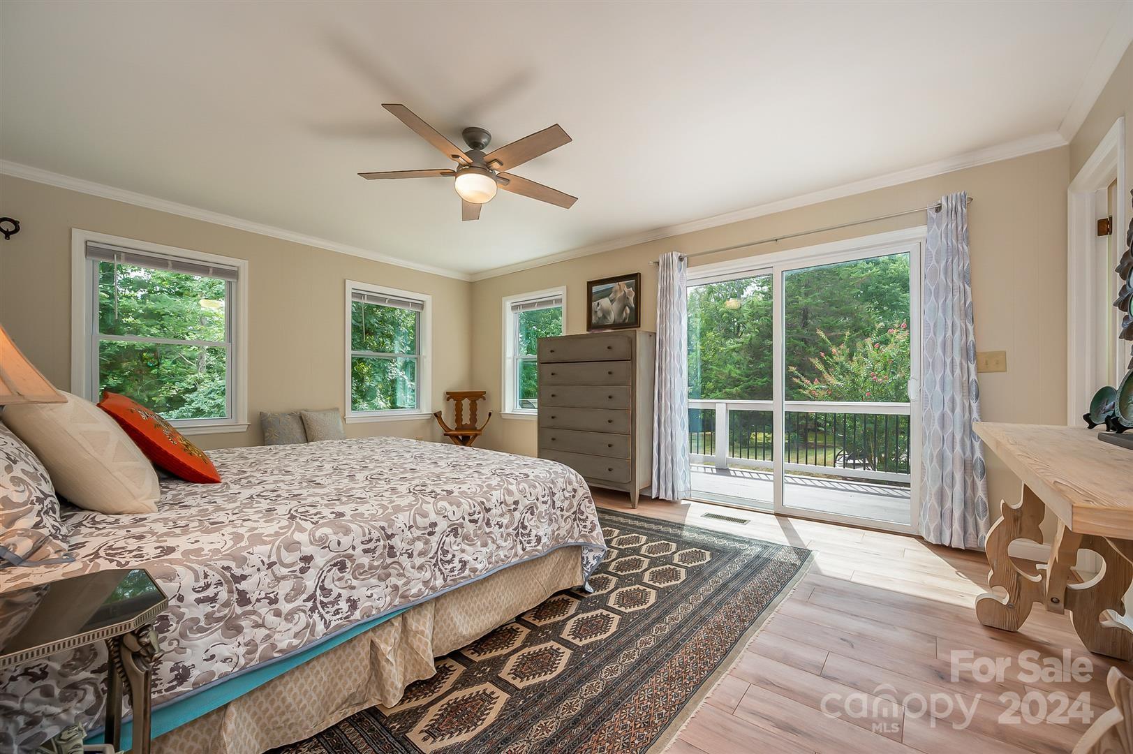 2316 Golf Course Road Columbus, NC 28722 - Photo 21 of 33 a bedroom with a large bed and a flat tv screen
