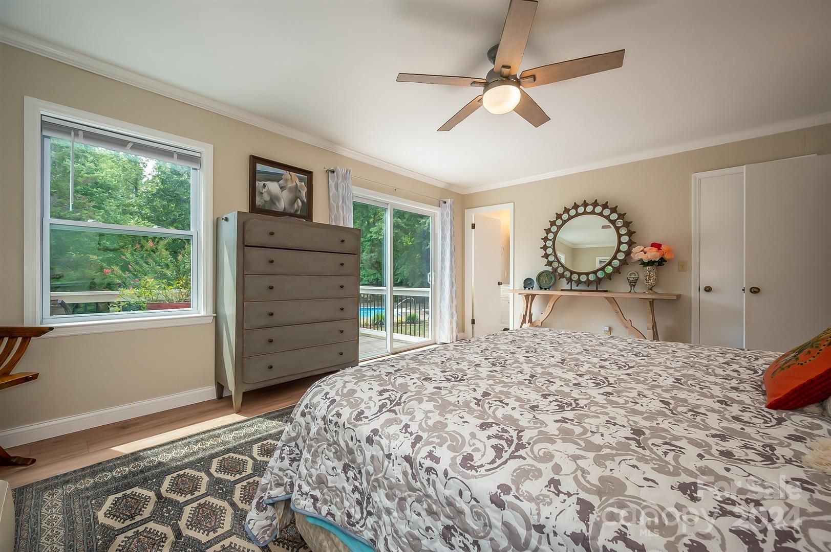 2316 Golf Course Road Columbus, NC 28722 - Photo 22 of 33 a bedroom with a bed and a dresser next to a window