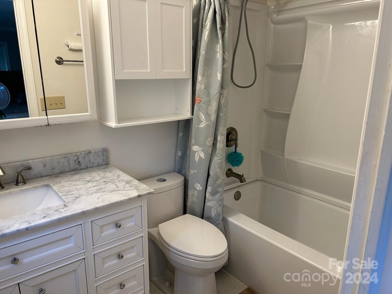 2316 Golf Course Road Columbus, NC 28722 - Photo 23 of 33 a bathroom with a granite countertop toilet sink and tub