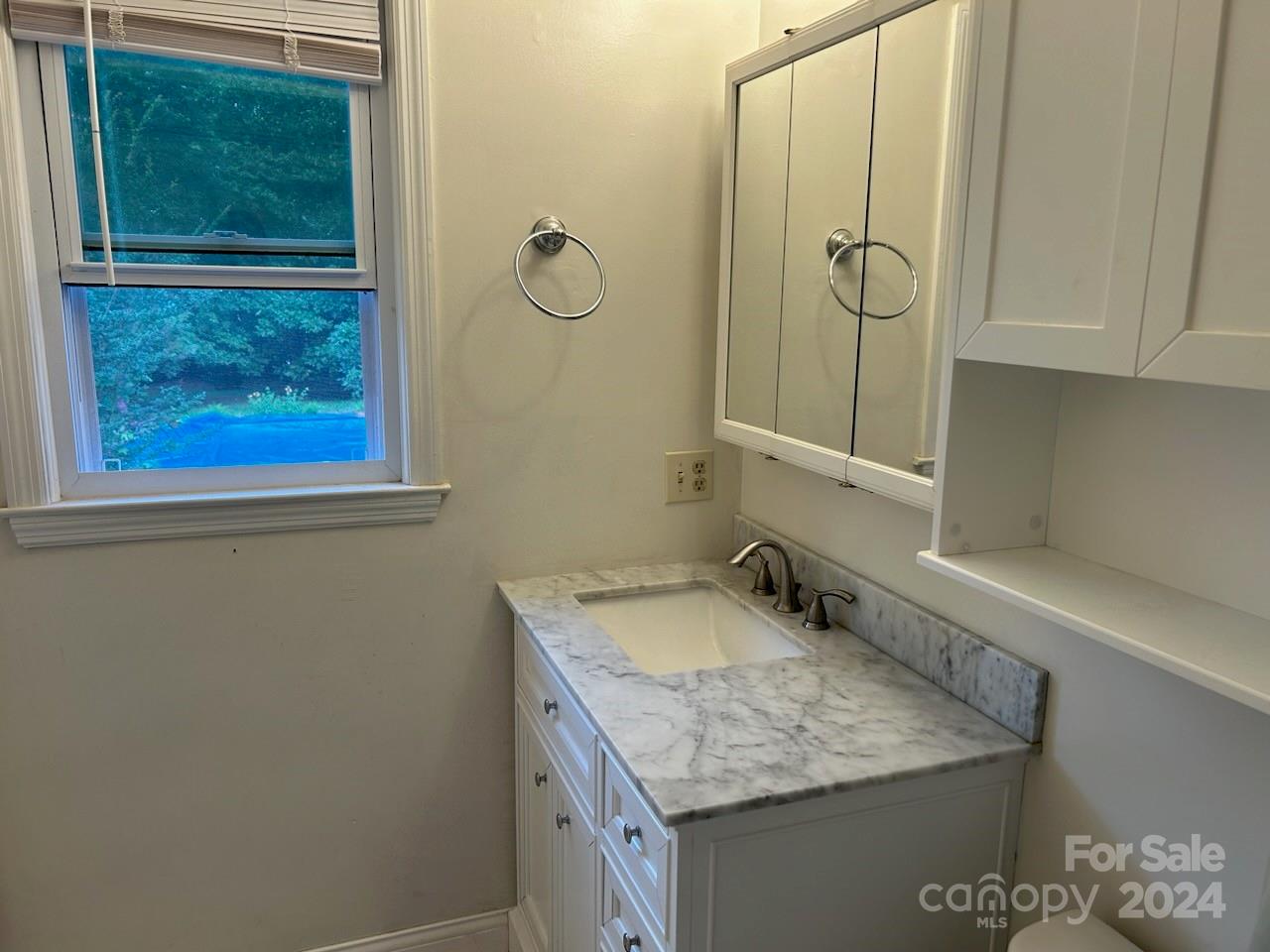 2316 Golf Course Road Columbus, NC 28722 - Photo 24 of 33 a bathroom with a granite countertop sink a mirror and shower
