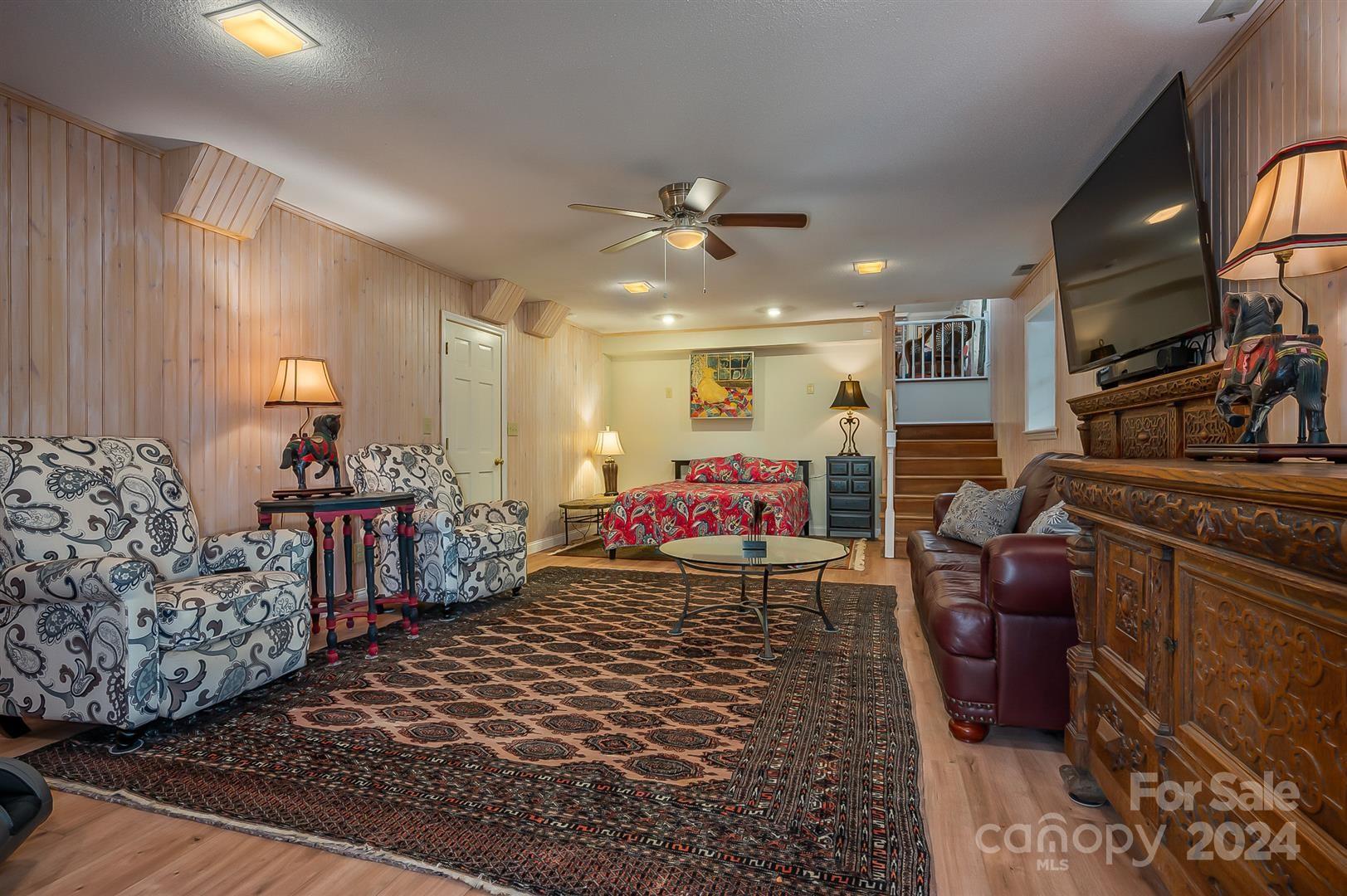 2316 Golf Course Road Columbus, NC 28722 - Photo 25 of 33 a living room with furniture and a flat screen tv