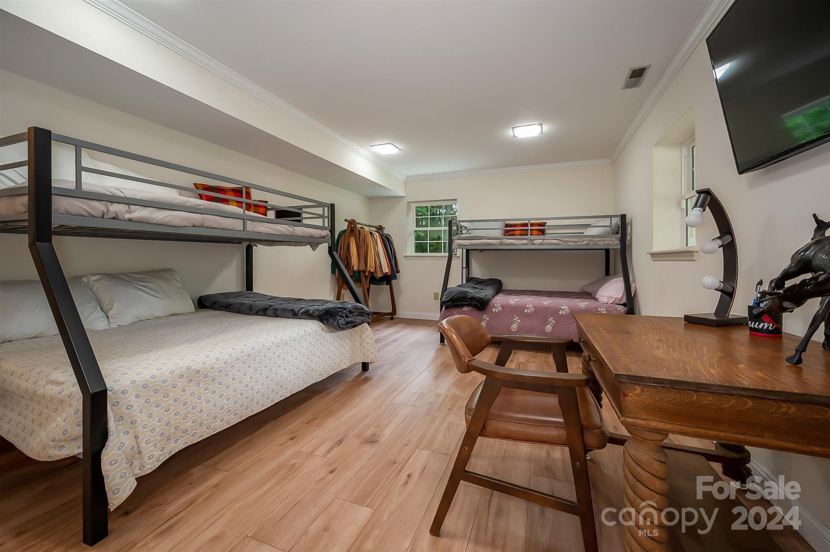 2316 Golf Course Road Columbus, NC 28722 - Photo 27 of 33 a bedroom with a bed and a flat screen tv