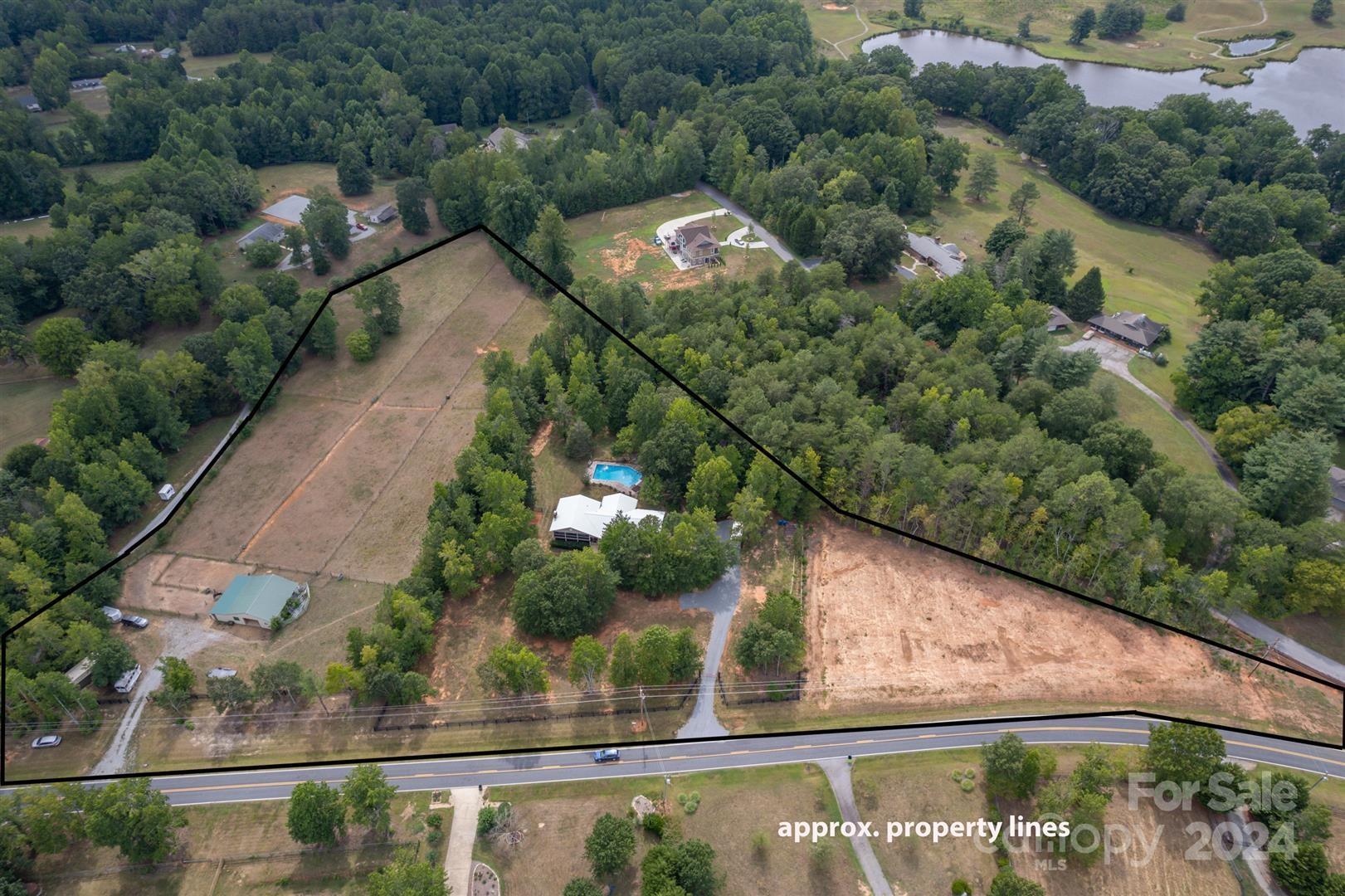 2316 Golf Course Road Columbus, NC 28722 - Photo 31 of 33 an aerial view of a house with a yard and lake view
