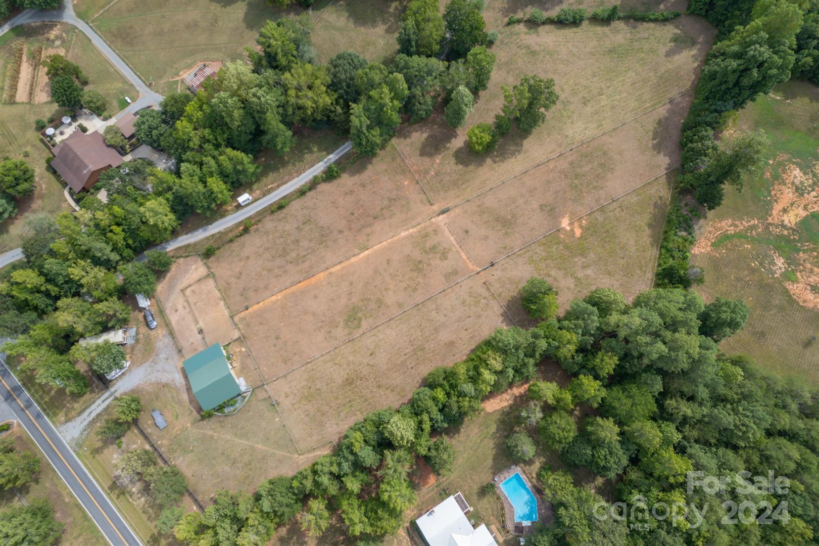 2316 Golf Course Road Columbus, NC 28722 - Photo 33 of 33 an aerial view of a house with a yard and a garden