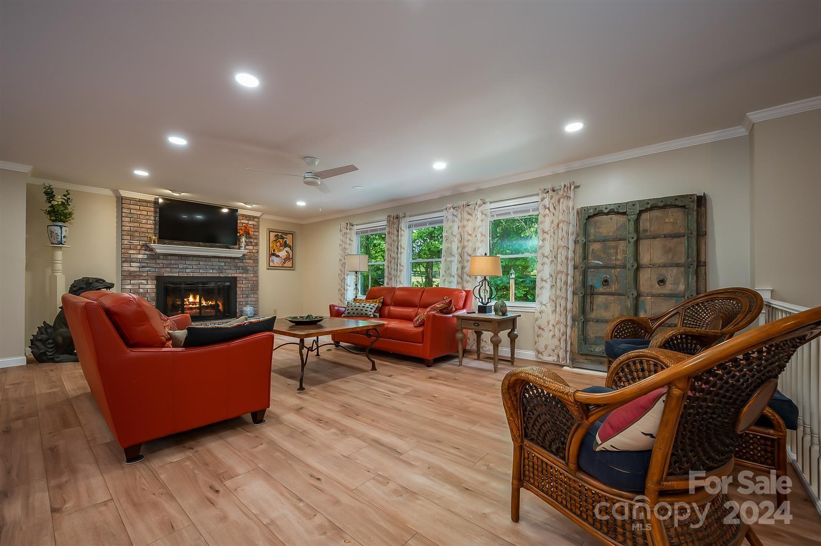2316 Golf Course Road Columbus, NC 28722 - Photo 8 of 33 a living room with furniture a flat screen tv and a fireplace