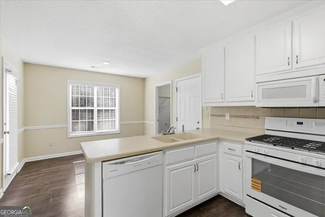 a kitchen with appliances cabinets and a sink
