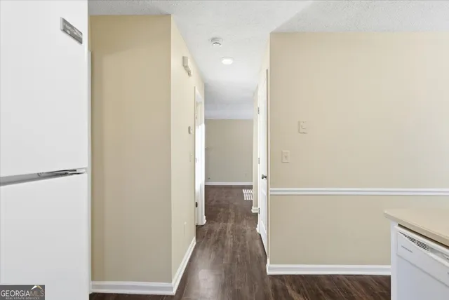 a view of a hallway with wooden floor