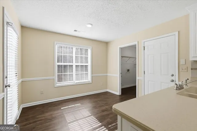 a spacious bedroom with a bed and a window