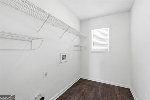 a view of a room with racks on the wall and a window