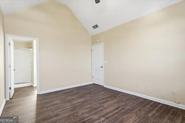 a view of an empty room with wooden floor