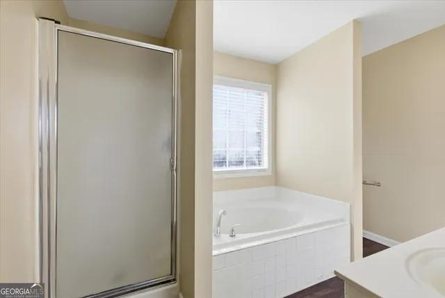 a bathroom with a tub and shower