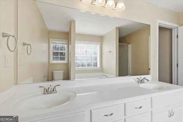 a bathroom with a tub sink and mirror
