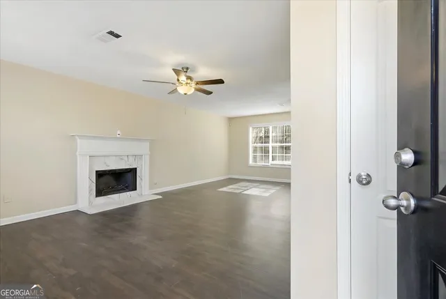 a view of an empty room with a fireplace