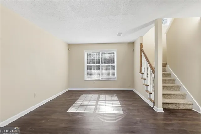 a view of wooden floor in a room with a window