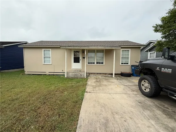 a car parked in front of white house