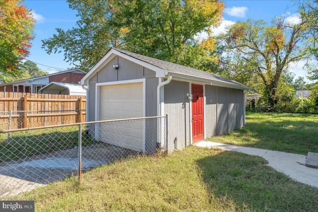 a view of backyard of house with green space