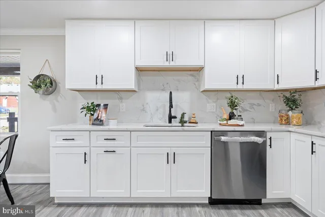 a kitchen with white cabinets and appliances
