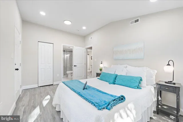 a bedroom with a bed and a lamp