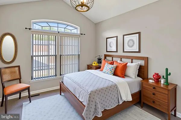 a bed room with a bed and a chair