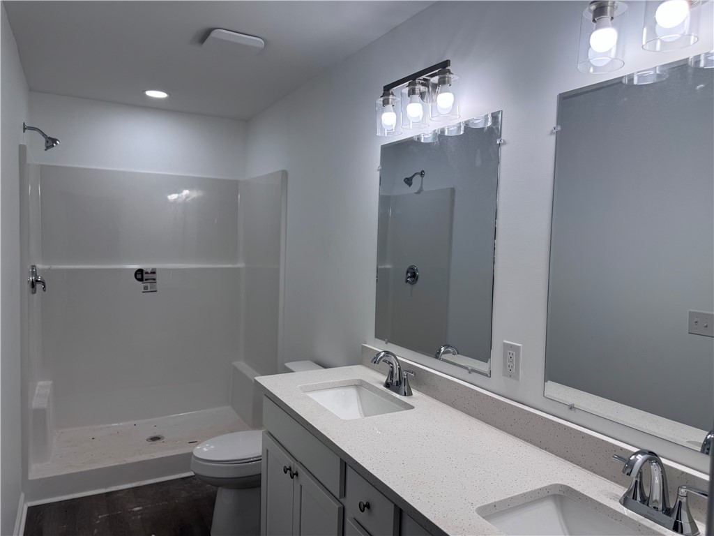 808 Delia Street Anderson, SC 29624 - Photo 10 of 17 Dual vanities complement the spacious shower area, providing a functional and well-appointed bathroom.