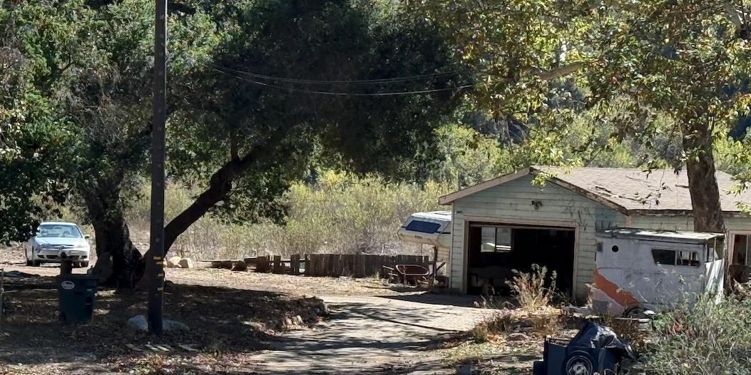 10406 Creek Road Oak View, CA 93022 - Photo 2 of 3 a house with trees in front of it