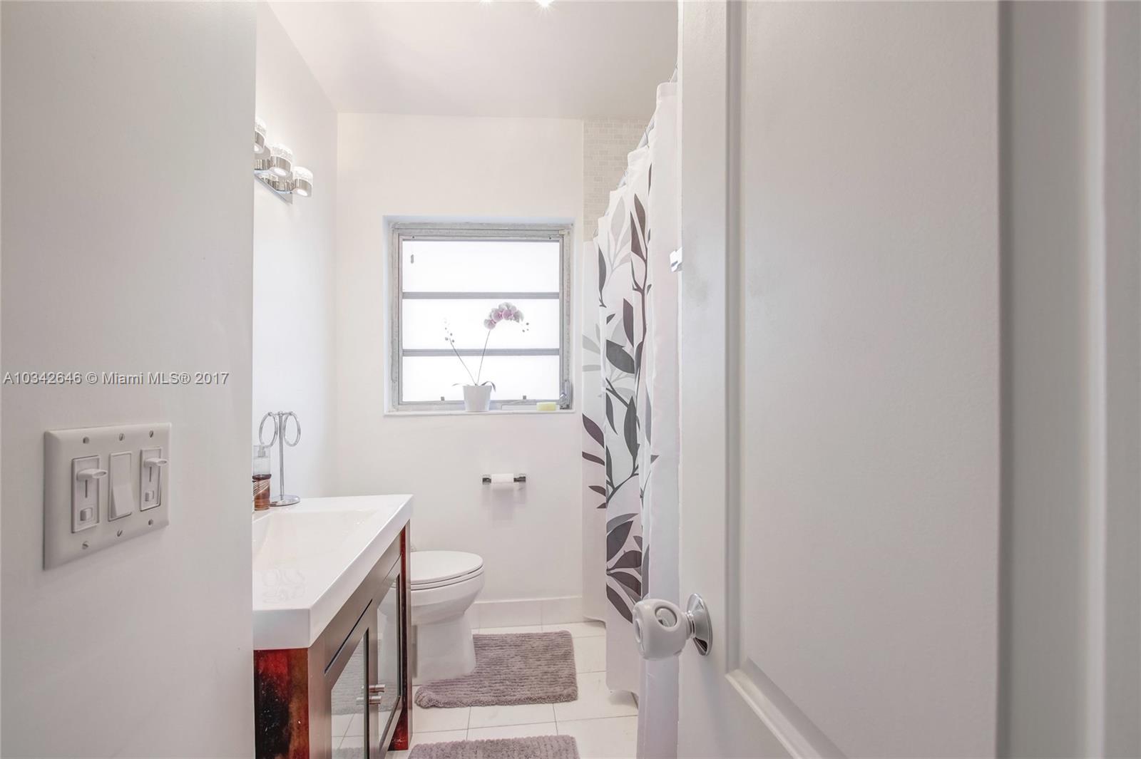 4300 Southwest 3rd Street Miami, FL 33134 - Photo 11 of 21 a bathroom with a sink toilet and shower