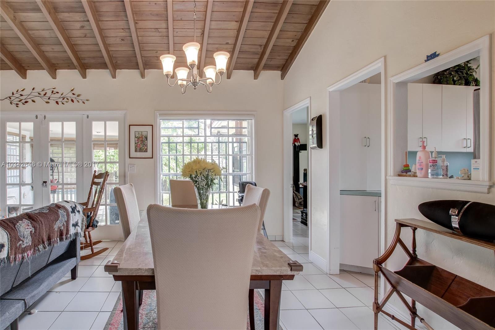 4300 Southwest 3rd Street Miami, FL 33134 - Photo 6 of 21 a living room with furniture and a chandelier
