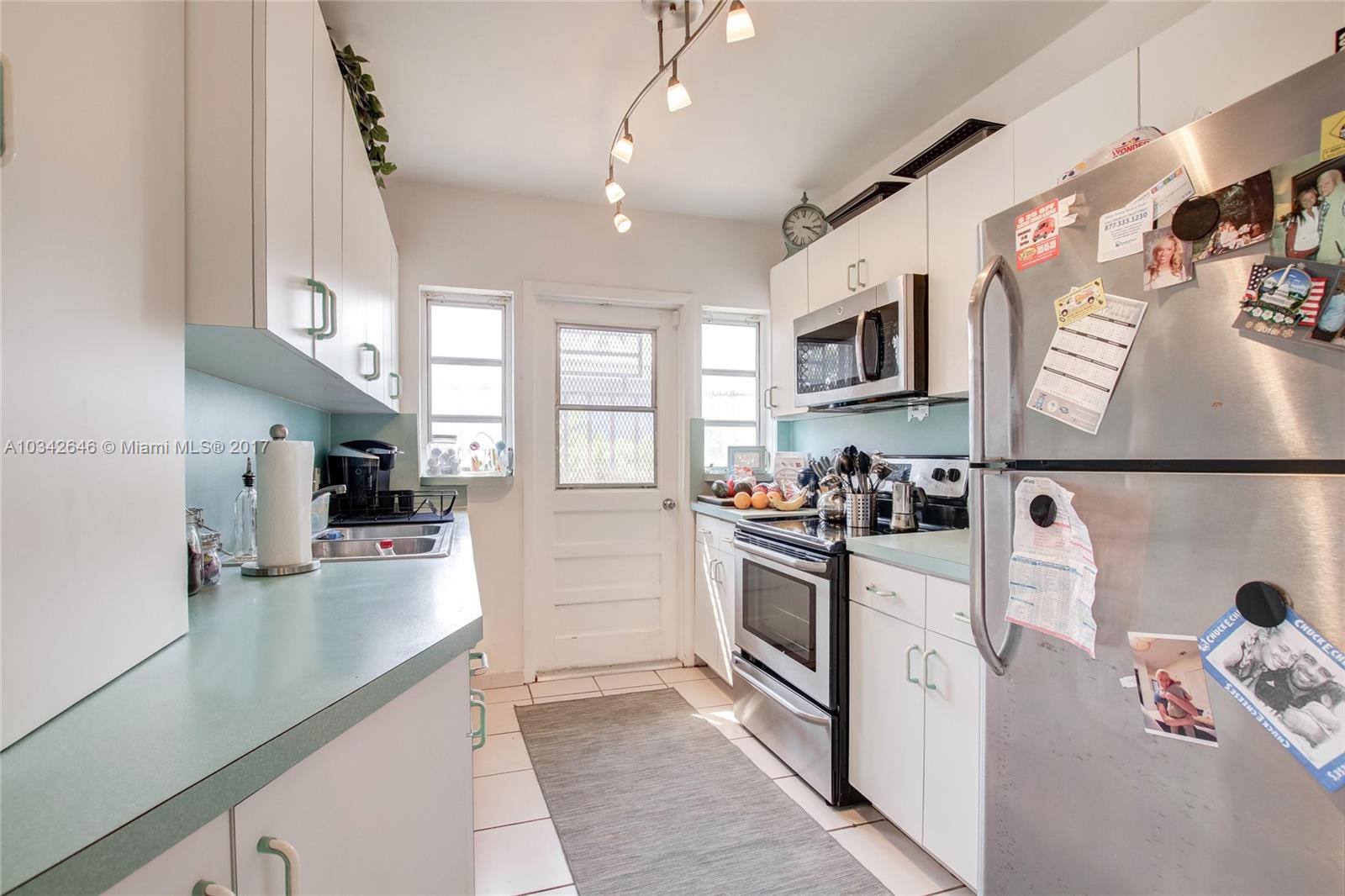 4300 Southwest 3rd Street Miami, FL 33134 - Photo 7 of 21 a kitchen with stainless steel appliances granite countertop a refrigerator and a sink